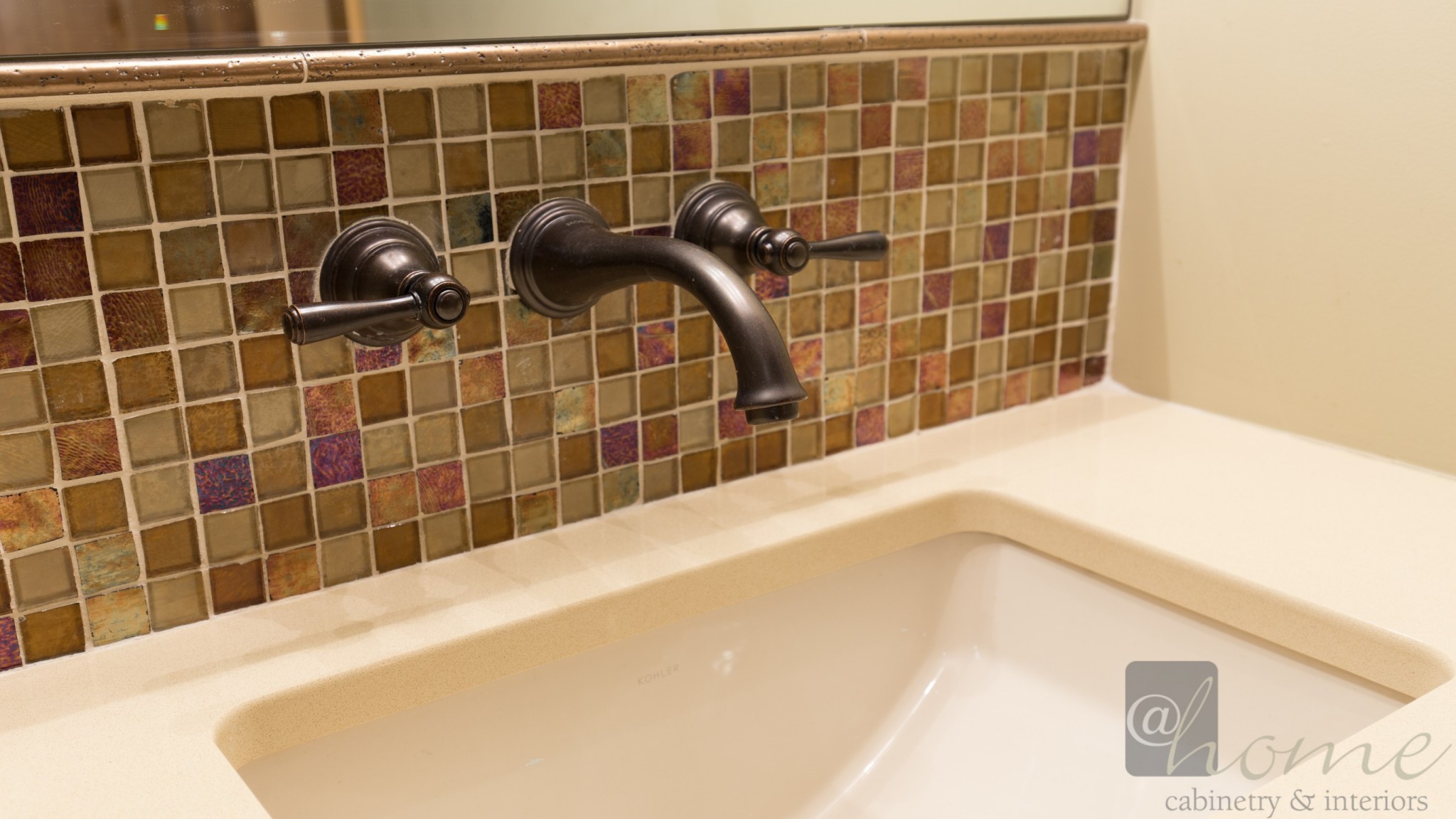 By repositioning the faucet to the wall we were able to create a shallower vanity that spanned the entire wall. It has that “wow” factor as well as provides ample storage for towels etc.